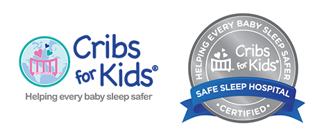 A logo for Cribs for Kids featuring a circular emblem with a stylized crib, three hearts above it, and a world map in the background. A circular silver badge with the words "Helping Every Baby Sleep Safer" around the top edge. The center features the Cribs for Kids® logo, with a crib and three hearts.